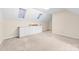 Bright bedroom featuring neutral carpet, built-in cabinets, and skylights at 13223 Willow Breeze Ln, Huntersville, NC 28078