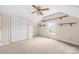 A bedroom has neutral carpet, a ceiling fan, a closet, and shelving at 13223 Willow Breeze Ln, Huntersville, NC 28078