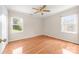 Comfortable bedroom features hardwood floors and bright windows with green views at 13223 Willow Breeze Ln, Huntersville, NC 28078