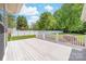 Large backyard deck with white railing overlooks the lawn and fenced yard at 13223 Willow Breeze Ln, Huntersville, NC 28078