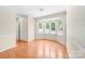 Dining area with hardwood floors and a bay window offering natural light at 13223 Willow Breeze Ln, Huntersville, NC 28078