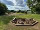 Relaxing fire pit with benches, in the middle of a sports park, adding comfort and recreation to the community at 13223 Willow Breeze Ln, Huntersville, NC 28078