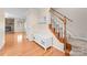 Welcoming foyer with hardwood floors, staircase, and decorative bench storage. Neutral paint palette at 13223 Willow Breeze Ln, Huntersville, NC 28078