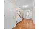 Bright foyer with hardwood floors, coat closet, bench, and staircase to the second level at 13223 Willow Breeze Ln, Huntersville, NC 28078