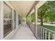 Long covered porch provides ample space and features decorative blue shutters on the exterior windows at 13223 Willow Breeze Ln, Huntersville, NC 28078