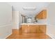 Well-lit kitchen with wooden cabinets, a breakfast bar, and hardwood floors at 13223 Willow Breeze Ln, Huntersville, NC 28078