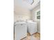 Well-equipped laundry room with full-size washer and dryer and wire shelving at 13223 Willow Breeze Ln, Huntersville, NC 28078