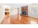 Open-concept living room featuring hardwood floors and brick fireplace. Easy access to kitchen at 13223 Willow Breeze Ln, Huntersville, NC 28078