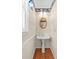 Charming powder room with a pedestal sink and decorative wallpaper trim at 13223 Willow Breeze Ln, Huntersville, NC 28078