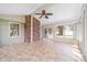 Cozy sunroom featuring a brick wall accent, tiled flooring, and abundance of natural light at 13223 Willow Breeze Ln, Huntersville, NC 28078