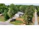 Aerial view of a cozy home surrounded by mature trees, offering privacy at 1406 High Shoals Rd, Lincolnton, NC 28092