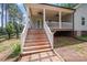 Stairway leading to the covered porch, with brick pavers adding a touch of elegance at 1406 High Shoals Rd, Lincolnton, NC 28092