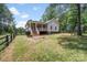Backyard featuring a covered porch, a wooden fence, and an adjacent patio at 1406 High Shoals Rd, Lincolnton, NC 28092