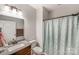 This bathroom features a granite vanity, a toilet, and a bathtub with shower at 1406 High Shoals Rd, Lincolnton, NC 28092