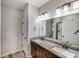 Bathroom featuring double sinks, granite countertops, and a walk-in shower at 1406 High Shoals Rd, Lincolnton, NC 28092