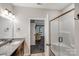 Bathroom with shower, vanity, and views into the main bedroom at 1406 High Shoals Rd, Lincolnton, NC 28092