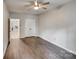 A sun-lit bedroom features wood-look floors, closet, and a view into another room at 1406 High Shoals Rd, Lincolnton, NC 28092