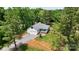 Charming home nestled among mature trees, with a large lawn and gravel driveway at 1406 High Shoals Rd, Lincolnton, NC 28092
