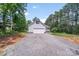 Detached garage with ample parking and a quaint front porch in a wooded setting at 1406 High Shoals Rd, Lincolnton, NC 28092