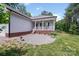 Inviting front porch with a brick foundation, creating a welcoming curb appeal at 1406 High Shoals Rd, Lincolnton, NC 28092
