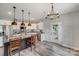 Open kitchen featuring a large island, stainless appliances, granite counters, and wood-look flooring at 1406 High Shoals Rd, Lincolnton, NC 28092