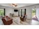 Cozy living room with leather sofa, ceiling fan, and natural light at 1406 High Shoals Rd, Lincolnton, NC 28092
