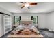 Bright bedroom featuring barn door, ceiling fan, and hardwood floors at 1406 High Shoals Rd, Lincolnton, NC 28092