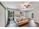 Comfortable main bedroom with barn door, ceiling fan, and natural light at 1406 High Shoals Rd, Lincolnton, NC 28092