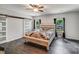 Charming bedroom with a ceiling fan, wood floors, and barn door at 1406 High Shoals Rd, Lincolnton, NC 28092
