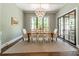 Formal dining room with a large window, elegant chandelier, and ample space for entertaining at 14228 Ryker Way, Davidson, NC 28036