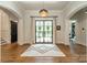 Elegant foyer featuring hardwood floors, a stylish rug, statement lighting, arched doorways and a view of the backyard at 14228 Ryker Way, Davidson, NC 28036