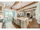Open concept kitchen with marble island, stainless steel appliances and open view to living and dining area at 14228 Ryker Way, Davidson, NC 28036