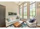 Spacious living area filled with natural light from large windows, complemented by stylish furnishings and decor accents at 14228 Ryker Way, Davidson, NC 28036