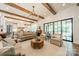 Open living area with exposed wood beams, flowing into a modern kitchen, ideal for gatherings and everyday living at 14228 Ryker Way, Davidson, NC 28036