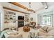 Inviting living room boasting exposed wooden beams, a cozy fireplace, custom built-ins and ample natural light at 14228 Ryker Way, Davidson, NC 28036