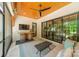 Relaxing screened porch with a ceiling fan, mounted tv, and an inviting lounge area perfect for enjoying the outdoors at 14228 Ryker Way, Davidson, NC 28036