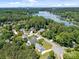 Aerial shot showcasing a community near a lake, surrounded by lush forests and serene landscapes at 148 Spring Grove Dr, Mooresville, NC 28117