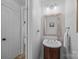 Charming half-bath featuring a pedestal sink, mirror, and updated fixtures at 148 Spring Grove Dr, Mooresville, NC 28117