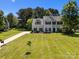 Inviting two-story home with a lush green lawn and a long driveway leading to the residence at 148 Spring Grove Dr, Mooresville, NC 28117