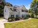 Well-maintained two-story home with attached garage, attractive landscaping, and manicured lawn at 148 Spring Grove Dr, Mooresville, NC 28117