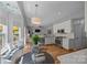 Open kitchen and breakfast nook with hardwood floors and modern lighting at 148 Spring Grove Dr, Mooresville, NC 28117