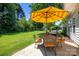 Cozy outdoor patio featuring a table and chairs under a yellow umbrella, ideal for relaxation at 148 Spring Grove Dr, Mooresville, NC 28117