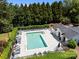 Aerial view of a sparkling community swimming pool with ample lounge chairs and a surrounding tree line at 148 Spring Grove Dr, Mooresville, NC 28117