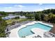 Community pool with lounge chairs and a lake view on a sunny day at 148 Spring Grove Dr, Mooresville, NC 28117