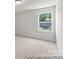 Bright bedroom with neutral carpeting, light gray walls, and a window with natural light at 1503 Autumn Banks Way # 3P, High Shoals, NC 28077
