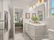 Bright bathroom vanity with double sinks, white cabinets, and a decorative mirror at 1509 Autumn Banks Way # 4P, High Shoals, NC 28077