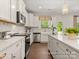 Bright kitchen featuring white cabinetry, stainless steel appliances, an island, and hardwood floors at 1509 Autumn Banks Way # 4P, High Shoals, NC 28077
