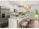 Modern kitchen with white cabinets, stainless steel appliances, marble backsplash, an island, and pendant lighting at 1509 Autumn Banks Way # 4P, High Shoals, NC 28077
