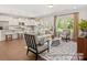Open concept living space with kitchen, island, living room, hardwood floors, and bright windows at 1509 Autumn Banks Way # 4P, High Shoals, NC 28077