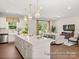 Open concept living space featuring a kitchen island, hardwood floors, and ample natural light at 1509 Autumn Banks Way # 4P, High Shoals, NC 28077